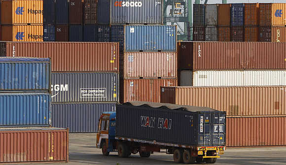 A truck ferries a shipping container at a port in Chennai.