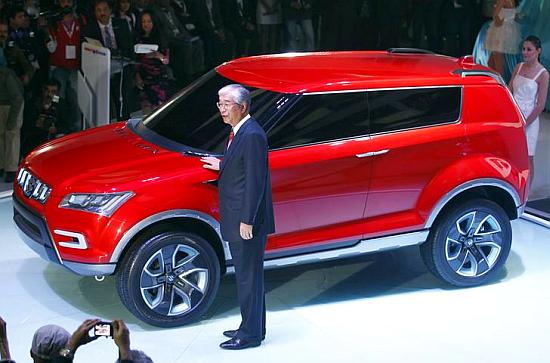 Shinzo Nakanishi, chief executive and MD of Maruti Suzuki poses with company's new compact SUV XA Alpha car.