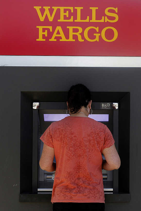 A customer uses an ATM machine at a Wells Fargo bank in Los Angeles, Calfornia.