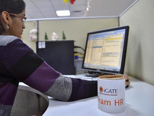 An employee works at the headquarters of iGate in Bengaluru.