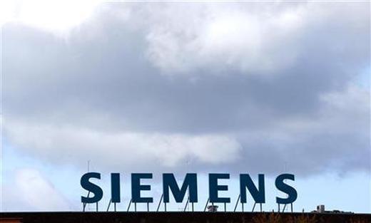 The logo of Siemens AG company is pictured atop a factory in Berlin.