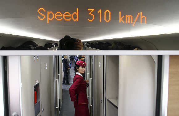 An attendant inside a high-speed train from Beijing to Zhengzhou.