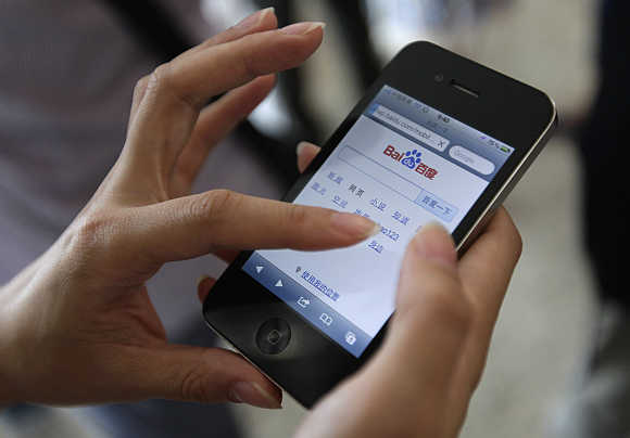 A user loads the Baidu homepage on her Apple iPhone 4 in Beijing.