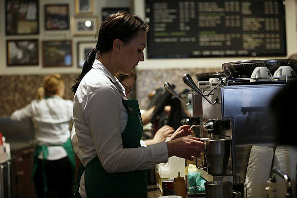 A barista prepares coffee at Starbucks.