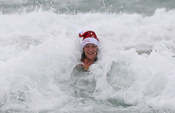 A woman enjoys the waves on a cold and windy Christmas day at Bondi Beach in Sydney.