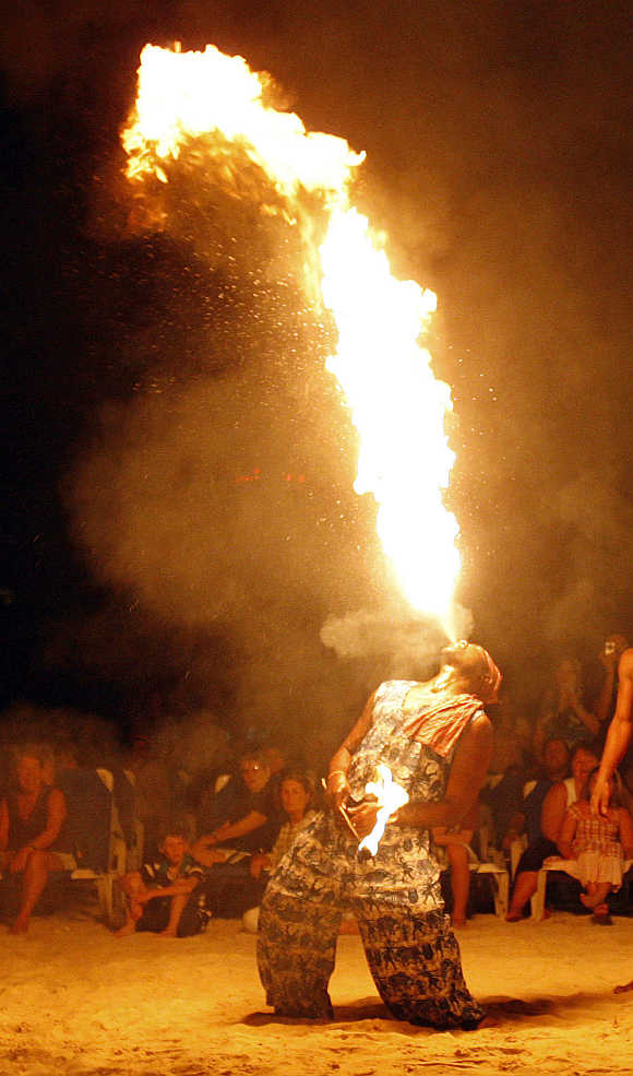 A performer blows a stream of fire during a show in Ocho Rios, Jamaica.