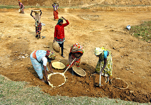 Village women work at a road construction site under the National Rural Employment Guarantee Act.