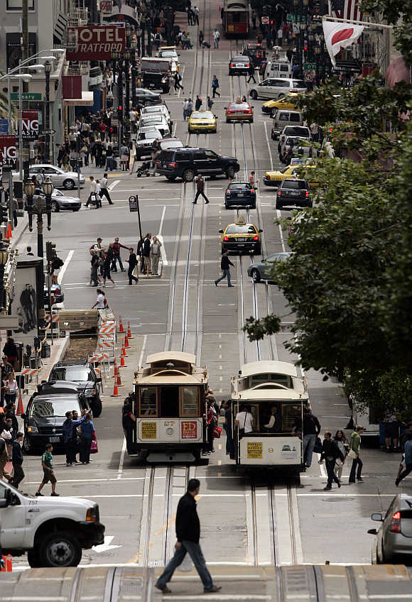 Cable cars pass each other along Powell Street in San Francisco, California.