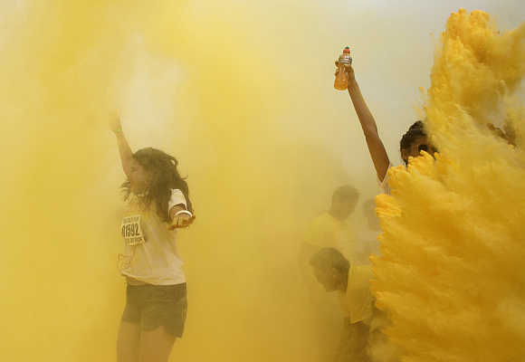 Participants are hit by coloured powder during the 'The Color Run' in Rio de Janeiro.