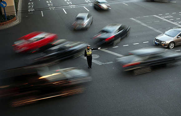 A policeman directs traffic in Shanghai.