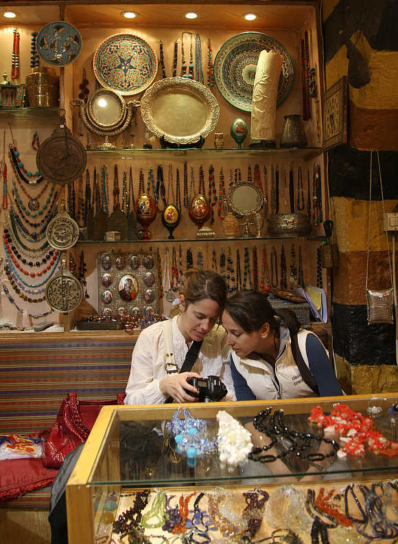 Western tourists visit a handicrafts shop in Old Damascus.