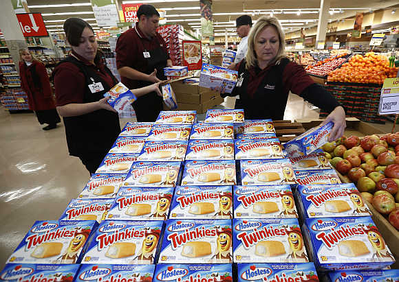 Workers unpack shipment of Twinkies at a Jewel-Osco grocery store in Chicago. Hostess owns Twinkies.