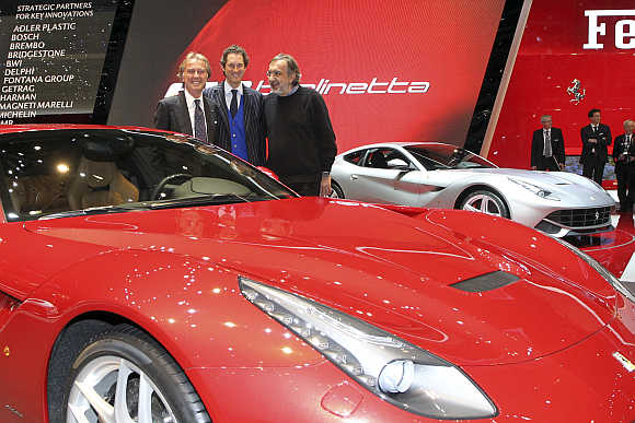 Ferrari CEO Luca Cordero di Montezemolo, Fiat Chairman John Elkann, and Fiat-Chrysler CEO Sergio Marchionne with Ferrari F12 Berlinetta in Geneva.