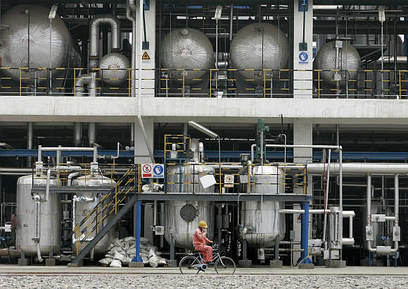 A worker cycles inside CNPC Lanzhou Chemical Company in Lanzhou, China.