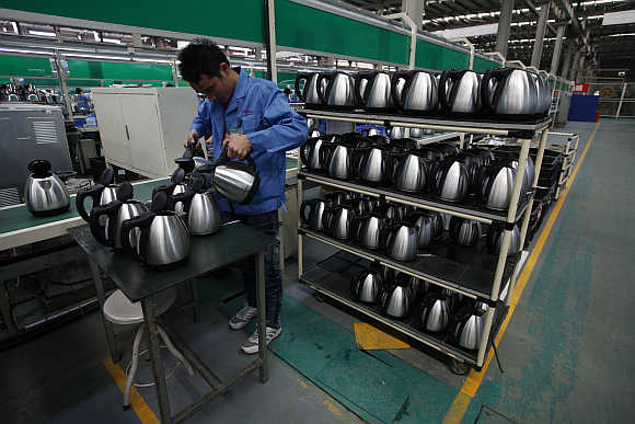An employee tests electric kettles in Zhongshan, southern Chinese province of Guangdong.