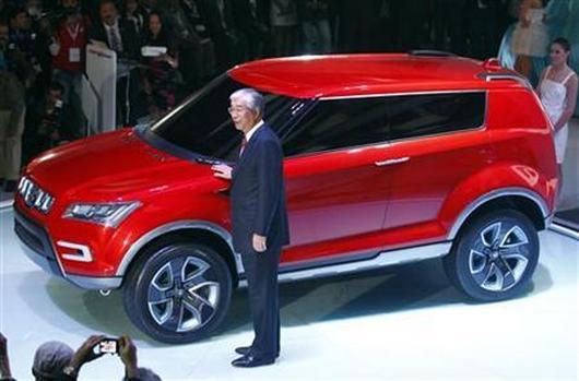 Shinzo Nakanishi, chief executive and managing director of Maruti Suzuki, poses with company's new compact SUV XA Alpha.
