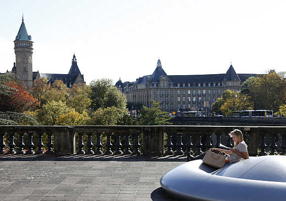 A woman reads during sunny day in the city of Luxembourg.