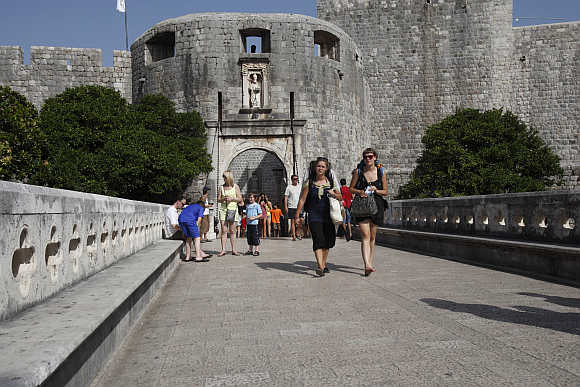 Tourists walk out of Old Town in Dubrovnik.