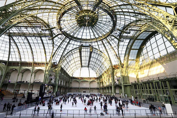 Skaters enjoy the ice on a giant ice rink at the Grand Palais exhibition hall in Paris.