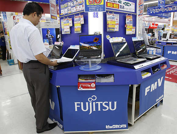 A man takes a look at Fujitsu's laptop at an electronics store in Tokyo.
