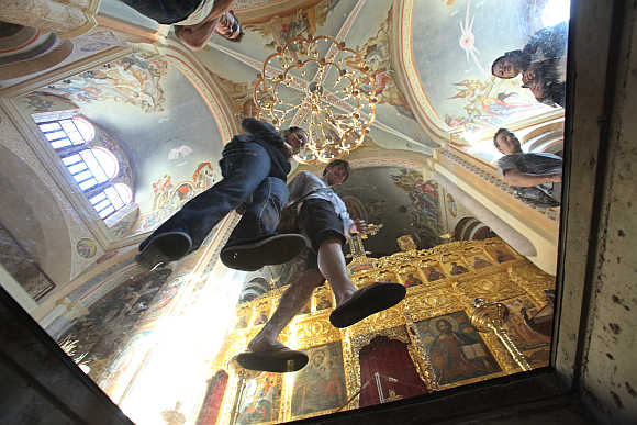 People look down at a crypt museum at Saint George Orthodox Cathedral in Beirut.