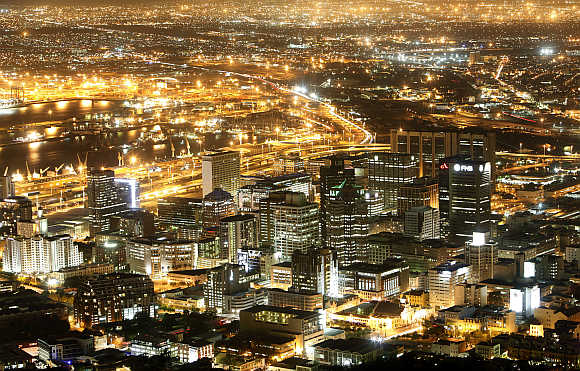 Cape Town's business district lights up as dusk falls over the city.