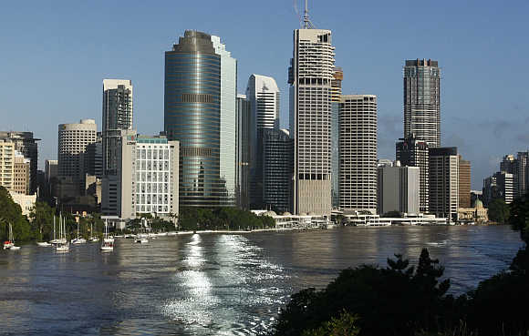 Brisbane River is seen flowing past the skyline of central Brisbane.