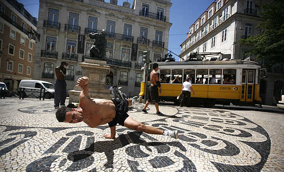 Alan Silva, 24, dances in downtown Lisbon, Portugal.