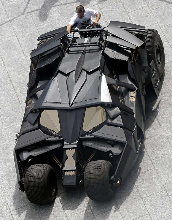 A workman polishes The Tumbler Batmobile during a promotional stop in downtown Toronto, Canada.