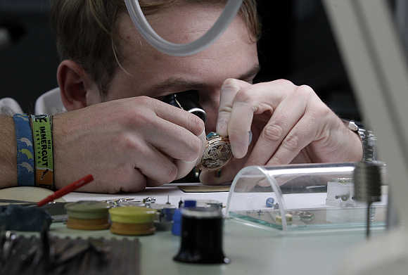 A worker checks a watch by German watchmaker A Lange & Soehne in Glashuette, Germany.