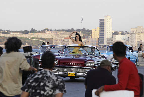 A camera crew films Salman Khan and Katrina Kaif in a convertible car on Havana's seafront boulevard El Malecon in Cuba.