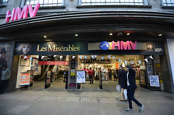Shoppers pass an HMV shop in central London.