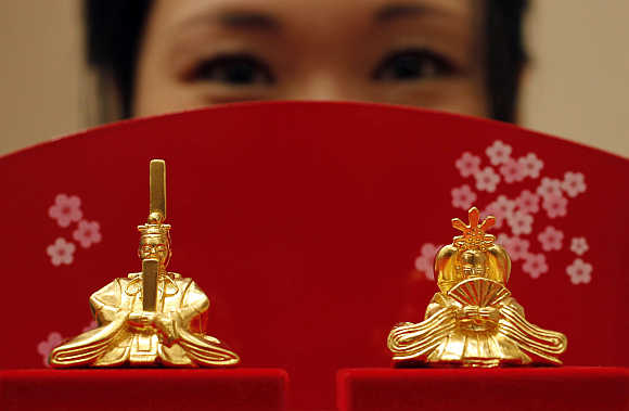 Japanese ornamental 'hina' dolls, made of pure gold, is unveiled at the Ginza Tanaka store in Tokyo.