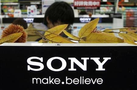 A man stands behind Sony Corp's logo at an electronics store in Tokyo.