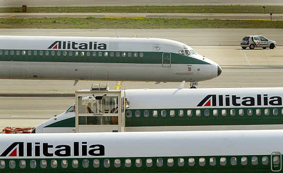 Alitalia aeroplanes taxi at Malpensa Airport on the outskirts of Milan, Italy.