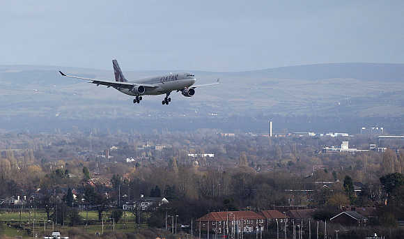A Qatar Airways aircraft prepares to land at Manchester Airport, England.