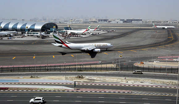 An Emirates Airlines plane taxis on the tarmac at the Dubai International Airport.