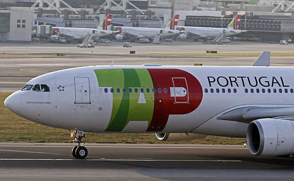 TAP Portugal airlines's Airbus 330 aircraft takes off at Lisbon airport.