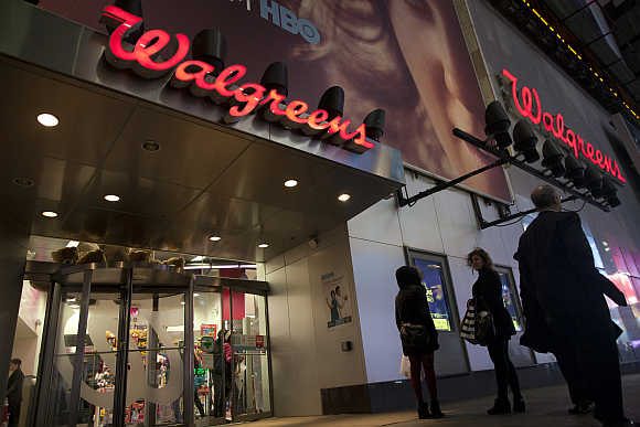 Shoppers walk by at the Walgreens' Times Square store in New York, United States.