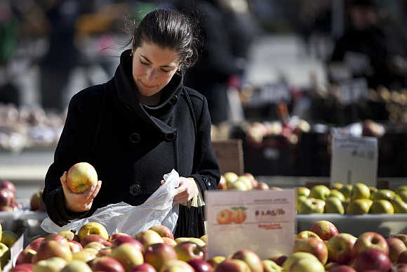 A woman shops for apples at a farmer's market in Union Square in New York.