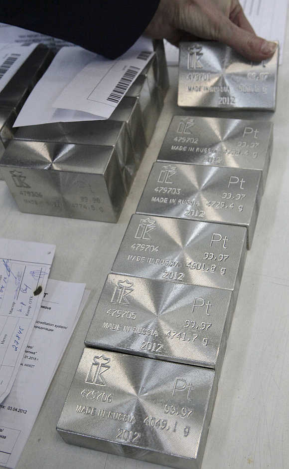 An employee sets out and sorts ingots of 99.97 per cent pure platinum at the Krastsvetmet nonferrous metals plant in Russia's Siberian city of Krasnoyarsk.