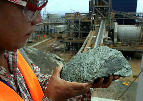 A mining engineer examines a mineralized ore containing copper and zinc in Lafayette Mining's open pit at Rapu Rapu island in the Philippines.