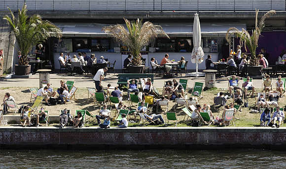 People enjoy a sunny day at River Spree in Berlin's Mitte district.
