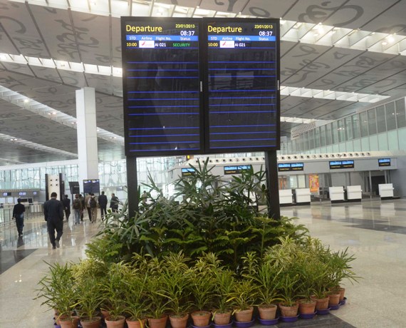 A display board indicates departure schedules of flights at the new Kolkata airport.