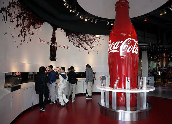 Patrons taste varieties of Coca-Cola at the World of Coca-Cola in Atlanta, Georgia, United States.