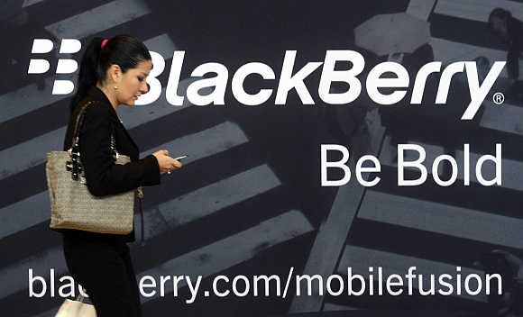 A woman uses her mobile phone at the BlackBerry World Event in Orlando, Florida, United States.