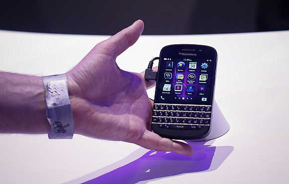 An attendee reaches out to grab a newly launched BlackBerry 10 device in New York.