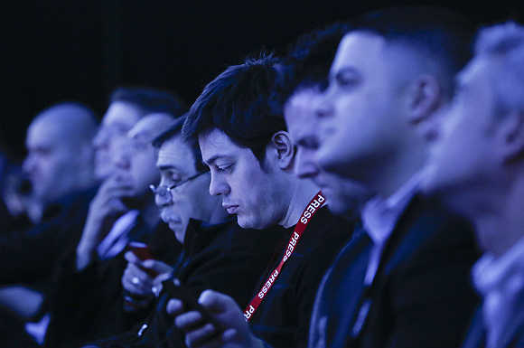 Audience members are tinted by stage lights at the launch of BlackBerry 10 devices in New York.