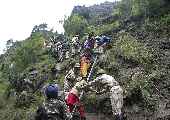 Soldiers rescue stranded people after heavy rains in the Himalayan state of Uttarakhand.
