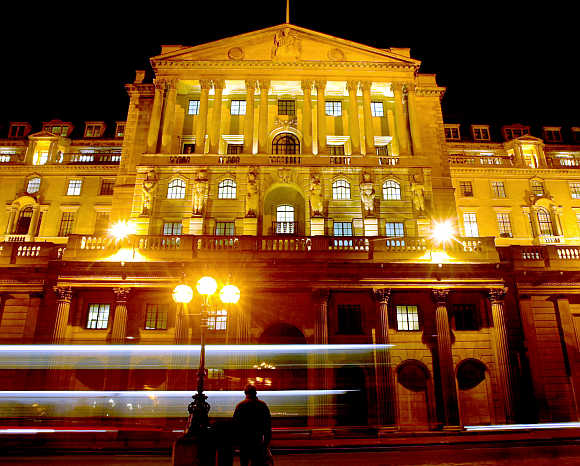 Bank of England is illuminated against the night sky in the City of London.